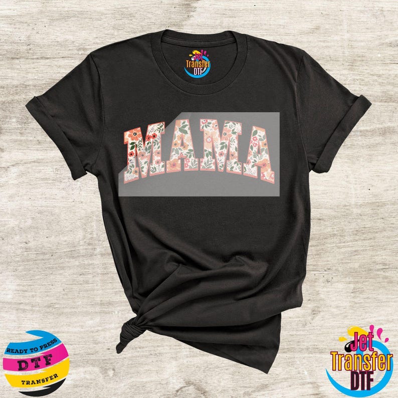 May include: Black t-shirt with a floral design that says "MAMA" in white letters.