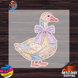 May include: A patchwork goose design with a purple bow and pearl-like trim. The goose features a variety of floral and patterned fabrics in pastel colors. The image includes the text "Transfer DTF" and "Ready to Press".