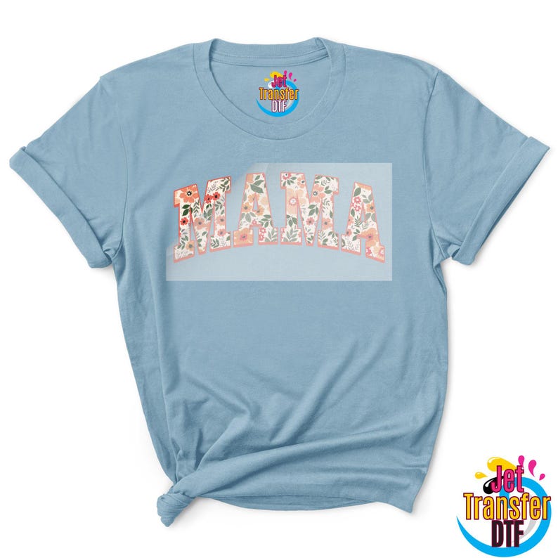 May include: A light blue t-shirt with a floral design that says "MAMA" in a bold, white font.