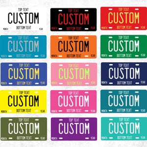 May include: A collection of fifteen rectangular license plates in various solid colors, each featuring the word CUSTOM in large capital letters, with placeholders for TOP TEXT, BOTTOM TEXT, MONTH, and YEAR printed in smaller font on each plate.