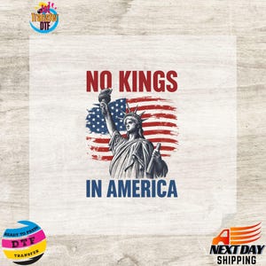 May include: A graphic featuring the Statue of Liberty in front of an American flag. The text "NO KINGS" is above the statue, and "IN AMERICA" is below. The image is a ready-to-press DTF transfer.