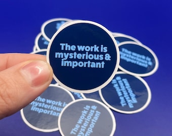 May include: A collection of navy blue circular stickers with the text "The work is mysterious & important" in light blue. The stickers are on a blue background.