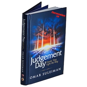 May include: A hardcover book titled "Judgement Day" by Omar Suleiman. The cover is dark blue with a vibrant illustration of a sunrise and beams of light. The text "Deeds That Light the Way" is also visible.