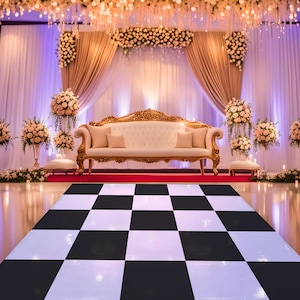 May include: A wedding reception setting with a black and white checkered dance floor. A white sofa with gold trim sits on a red carpet. Floral arrangements and draped curtains decorate the background.