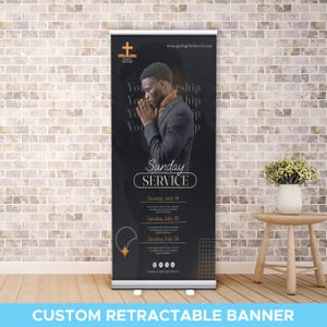 May include: A custom retractable banner with a black background and the words "Sunday Service." The banner features an illustration of a man praying and the church's logo. Dates for services are listed below the text.