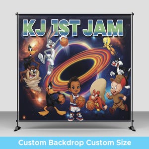 May include: A custom backdrop featuring the text "KJ 1st Jam" with cartoon characters like Bugs Bunny, Daffy Duck, and others. The backdrop has a space-themed background with a basketball and a young boy holding a basketball.
