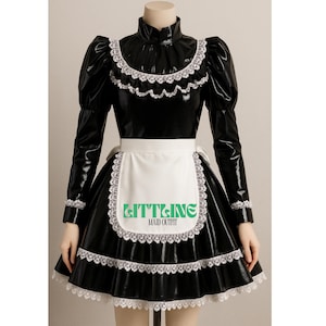 May include: Black maid outfit with a high collar, long sleeves, and a flared skirt. The outfit features white lace trim and a white apron with the text "GITT&INE MAID OUTFIT" in green.