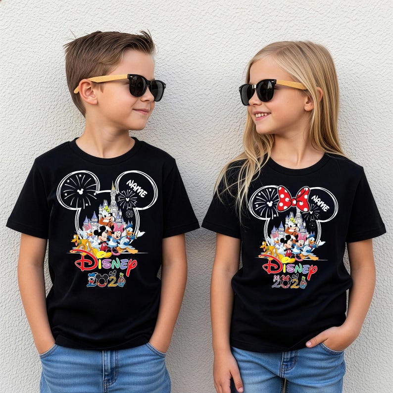 May include: Two black t-shirts featuring a white Mickey Mouse ear outline, a castle, fireworks, and Disney characters. The design includes the text "Disney 2020" and a placeholder for a name. The right shirt features a red and white polka dot bow.