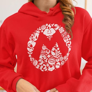 May include: A red hoodie featuring a white graphic design of various video game characters and icons arranged in a circular pattern. The design includes a smiling cloud, mushrooms, and the word "POW".
