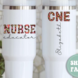 May include: White travel mug with a handle, featuring the words "NURSE educator" in a floral design. The other side has "CNE" in a floral design and the name "Elizabeth" in cursive. A green circle with "SHIPS FAST!" is also visible.