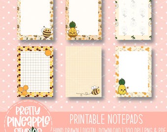 May include: Six printable notepads with various designs. The notepads feature illustrations of bees, pineapples, and flowers. The notepads have a white interior with decorative borders. The text "PRETTY PINEAPPLE STUDIOS" and "PRINTABLE NOTEPADS" are visible.