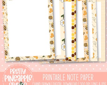 May include: Printable note paper with a bee and honeycomb theme. The design includes a large blank sheet of paper with a bee border, and several smaller sheets with different patterns. The text "Pretty Pineapple Studios" and "Printable Note Paper" are visible.