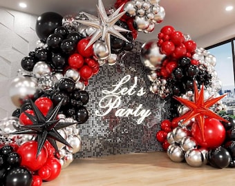 May include: A balloon arch made of red, black, and silver balloons. The arch is decorated with star-shaped balloons and the text "Let's Party".
