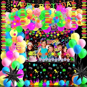 May include: A neon-themed party decoration set featuring a Happy Birthday banner, colorful balloons in pink, blue, yellow, and green, star-shaped cake toppers, and a black tablecloth with a vibrant paint splatter pattern and musical note graphics.