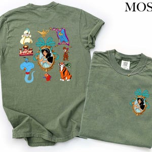 a green t-shirt with various cartoon characters and a small pocket on the front.