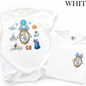 a white t-shirt with a Disney-themed design, including illustrations of Cinderella, a blue carriage, a pumpkin, and other Disney characters.