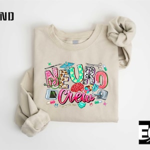 a beige t-shirt with a colorful graphic design on it, which appears to be a medical or healthcare-themed design.