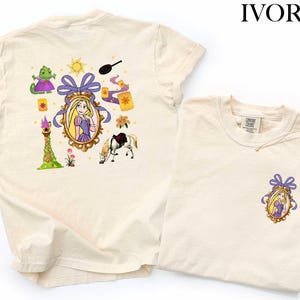 two white t-shirts with illustrations of characters from the Disney animated film " Rapunzel". The t-shirts are displayed side by side, with the larger t-shirt on the left and the smaller t-shirt on the right.