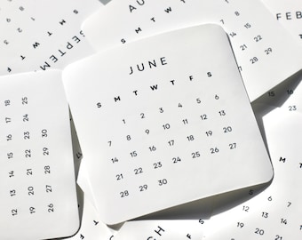 May include: A collection of white square calendar cards with rounded corners, featuring black sans-serif text. The central card displays the month of June with days of the week abbreviated as S M T W T F S and dates numbered 1 through 30 in a grid.