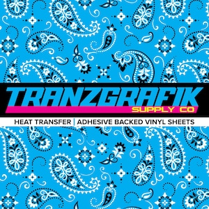 May include: A vibrant blue paisley pattern with black and white accents. The image features the text "TRANZGRAFIK SUPPLY CO" in bold blue letters with a pink underline, and the text "HEAT TRANSFER | ADHESIVE BACKED VINYL SHEETS" below.