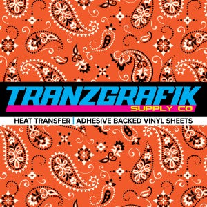 May include: Orange heat transfer vinyl sheet with a paisley pattern in black and white. The sheet has the text "TRANZGRAFIK SUPPLY CO" and "HEAT TRANSFER | ADHESIVE BACKED VINYL SHEETS" in black and white.
