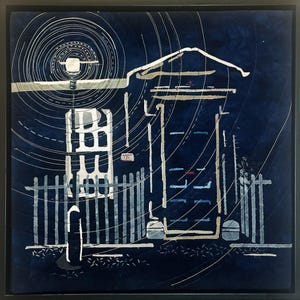 May include: A square textile wall art piece featuring a dark blue background with white stitched outlines of a house, a fence, and a street lamp. The design includes concentric circular stitching radiating from the lamp, creating a night scene.