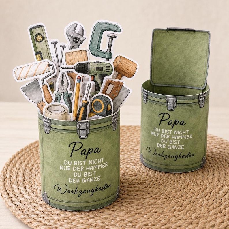 May include: Two olive green toolboxes with the text "Papa" and "Werkzeugkasten". One toolbox is open, and the other is closed. The open toolbox is filled with various tool cutouts, including a level, wrench, and drill.