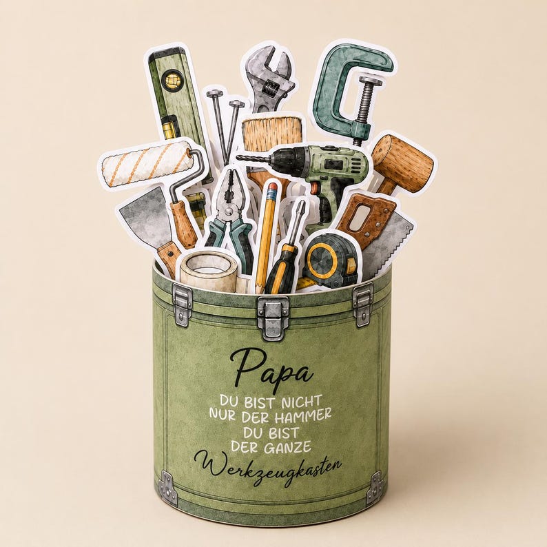 May include: A green toolbox-shaped card filled with various tools, including a level, wrench, drill, and saw. The card has the word "Papa" and German text on the front.