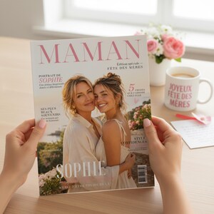 May include: A magazine cover with the title "MAMAN" in pink, featuring two women embracing. The cover also includes the text "F&ecirc;te des M&egrave;res" and "Sophie." A white mug with "Joyeux F&ecirc;te des M&egrave;res" is visible, along with a bouquet of pink roses.