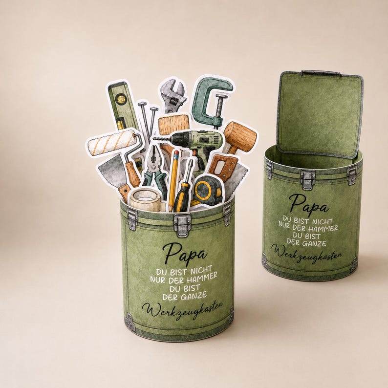 May include: Two olive green toolboxes, one open and one closed, with the text "Papa" and "Werkzeugkasten". The open toolbox is filled with tool illustrations. The text reads "You are not just the hammer, you are the whole toolbox."