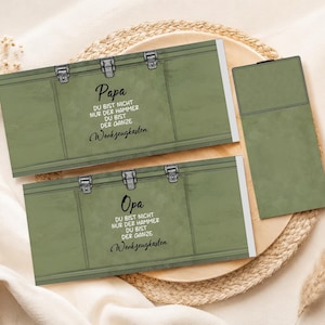 May include: Two olive green gift boxes with silver clasps and the German text "Papa" and "Opa". The text on the boxes reads "You are not just the hammer, you are the whole toolbox."
