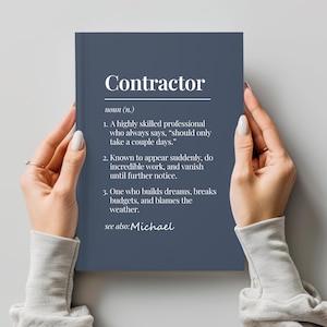 May include: A navy blue notebook with the word "Contractor" in white at the top. The definition of "Contractor" is listed below, including humorous descriptions. The text "see also: Michael" is at the bottom.