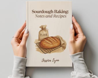 May include: A hardcover book titled Sourdough Baking: Notes and Recipes by Jessica Lynn. The cream-colored cover features a brown illustration of a loaf of bread on a wire cooling rack next to a sack labeled Flour, all in a brown ink style.