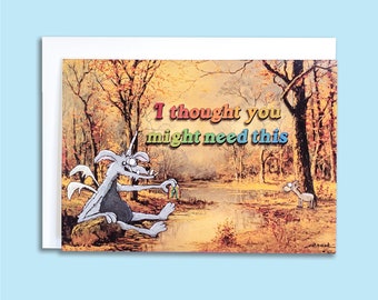 May include: A humorous greeting card featuring a cartoon creature in a forest setting. The creature is holding a ring and the text reads "I thought you might need this".