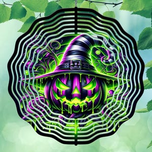 May include: A Halloween-themed wind spinner featuring a purple and green jack-o'-lantern wearing a witch's hat. The design is surrounded by a black, wavy, circular frame. The image has a neon glow effect.