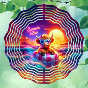 May include: A decorative wind spinner featuring a cartoon Highland cow wearing heart-shaped sunglasses and floating in a pink and white striped inner tube. The background shows a sunset over the ocean with the text "Summer Vibes". The spinner has a layered, wavy design.
