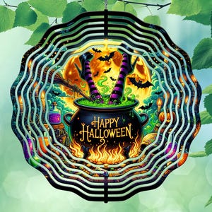 May include: A decorative Halloween-themed wind spinner with a circular design. The image features a cauldron with the text "Happy Halloween", witch legs, bats, and a full moon. The color palette includes black, orange, purple, and green.