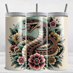 May include: Three stainless steel tumblers with a colorful tattoo-style design of a snake wrapped around flowers. The snake is black, brown, and red, and the flowers are red, yellow, and green.