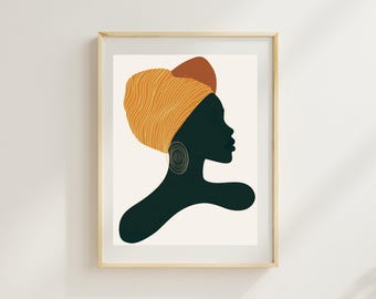 Può includere: Stampa artistica incorniciata con la silhouette di una persona che indossa un copricapo giallo e arancione e orecchini dorati. L'opera d'arte è ambientata su uno sfondo color crema e incorniciata in una cornice di legno chiaro. L'immagine ha uno stile minimalista e astratto.