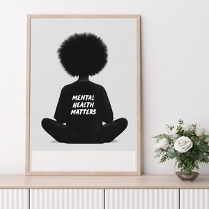 May include: Black and white illustration of a person sitting in a meditative pose with their back to the viewer. The person is wearing a black t-shirt with the text "Mental Health Matters" printed in white.