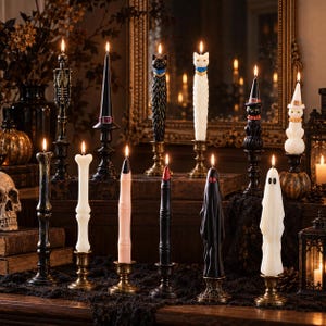 May include: A collection of twelve lit taper candles in various shapes including a skeleton, a witch hat, cats, ghosts, a finger, and bones. The candles are set in metallic holders and feature black, white, and pink wax colors.