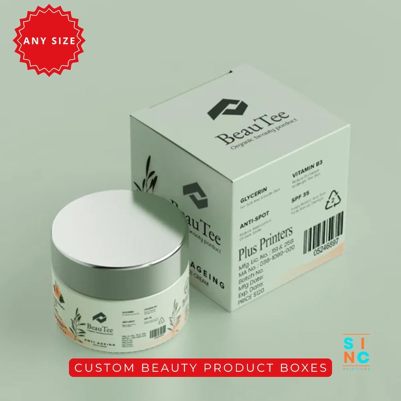 Puede incluir: Un frasco blanco y plateado de crema anti-edad BeauTee junto a una caja a juego. La caja y el frasco presentan el logotipo de BeauTee e informaci&oacute;n del producto. La imagen tambi&eacute;n incluye el texto "CUSTOM BEAUTY PRODUCT BOXES."