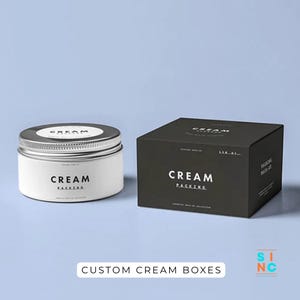 Puede incluir: Un tarro de crema blanco con tapa plateada y una caja negra con las palabras "CREAM PACKING" en blanco. El texto "CUSTOM CREAM BOXES" est&aacute; en la parte inferior de la imagen.