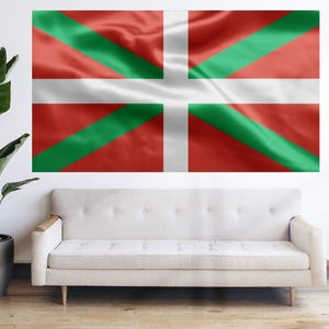May include: A white couch with a red, white, and green flag hanging on the wall behind it. The flag has a white cross in the center.