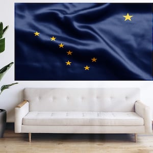 May include: A blue flag with a single large yellow star in the upper right corner and a constellation of seven smaller yellow stars in the upper left corner. The flag is made of a silky material and is slightly wrinkled.