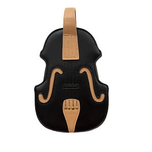 May include: A black violin-shaped handbag with tan detailing. The bag has a handle, decorative f-holes, and a bridge design. The bag is made of a smooth material and has a unique musical instrument theme.
