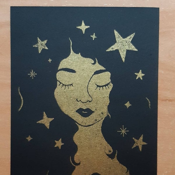 Starry hair - Gocco print, illustration in golden on black cardboard.