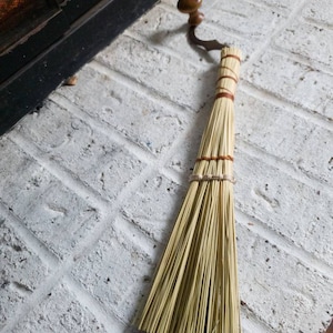 Unique grinder handled hearth broom