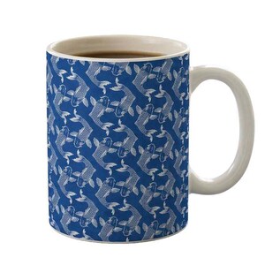 May include: White ceramic coffee mug with a blue background and a repeating pattern of white koi fish. The mug has a white handle and a light brown interior, perfect for enjoying your favorite beverage.