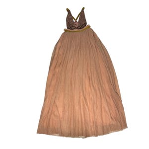 May include: A floor-length, peach-colored dress with a pleated skirt and a halter-style top. The top is a darker shade of brown with a green trim. The dress has a flowing, elegant design.